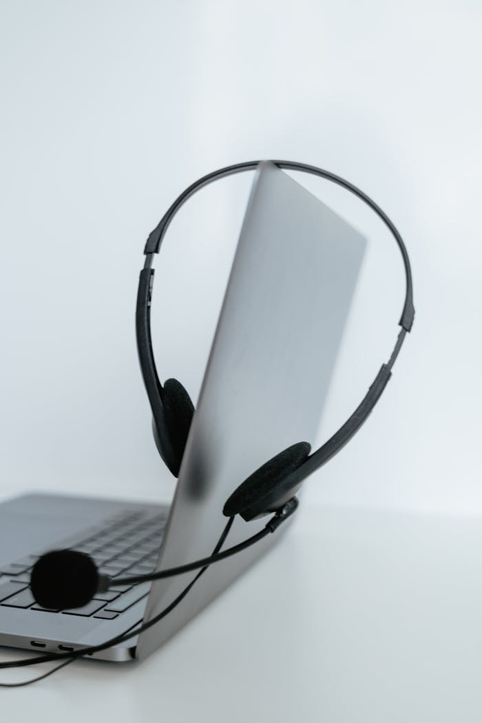 A sleek laptop with a headset, ideal for remote work or online communication.